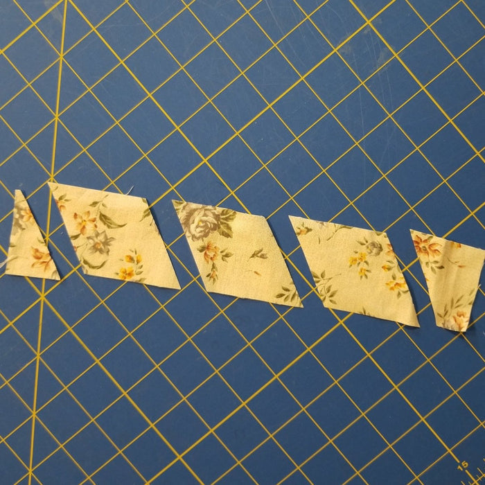 Hexagon shaped fabric pieces cut with Creative Shape Cut Ruler 6½" x 13½".