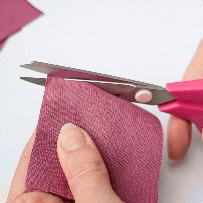 Madam Sew Medium Fabric Scissors cutting a variety of fabrics, trims and button.