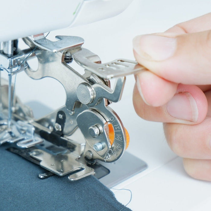hand changing the setting on the Madam Sew ruffler foot