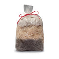 Woodland Treat Basket Refill: A clear cellophane bag with a red ribbon, containing three layers of natural nesting material for birds: cotton, aspen, and Spanish moss.